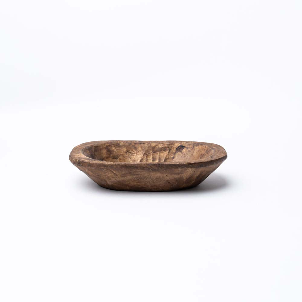 Small rough carved wood bowl on a white background