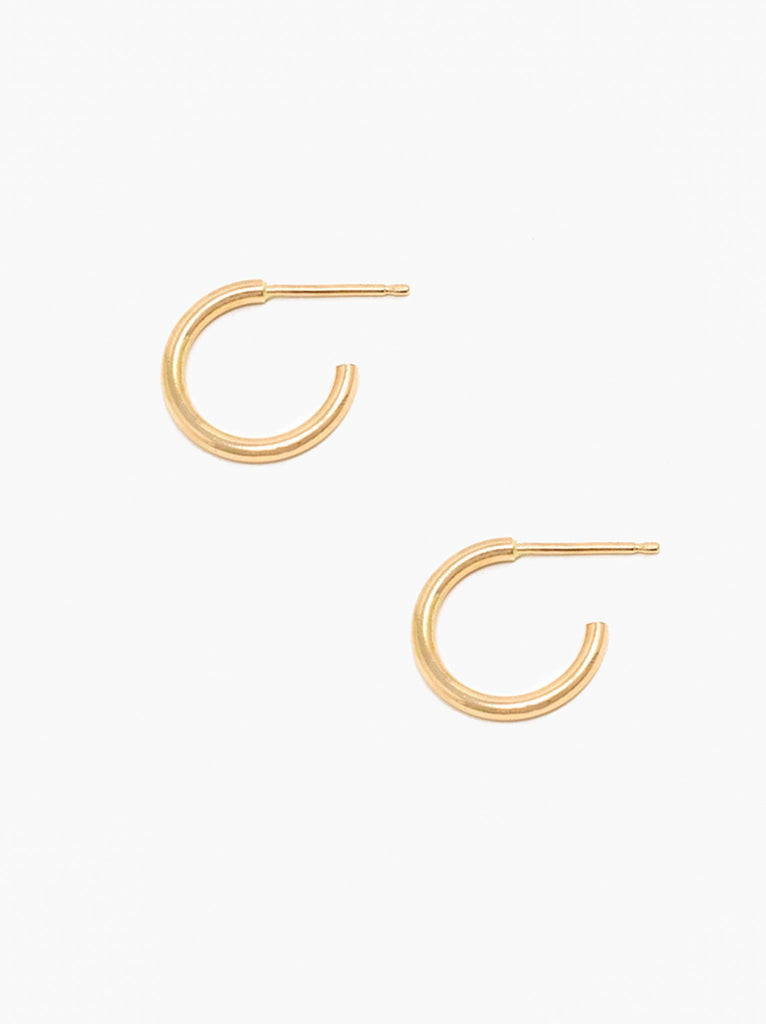 Able brand Celine Huggie Hoops in 14 carat gold fill on a white background