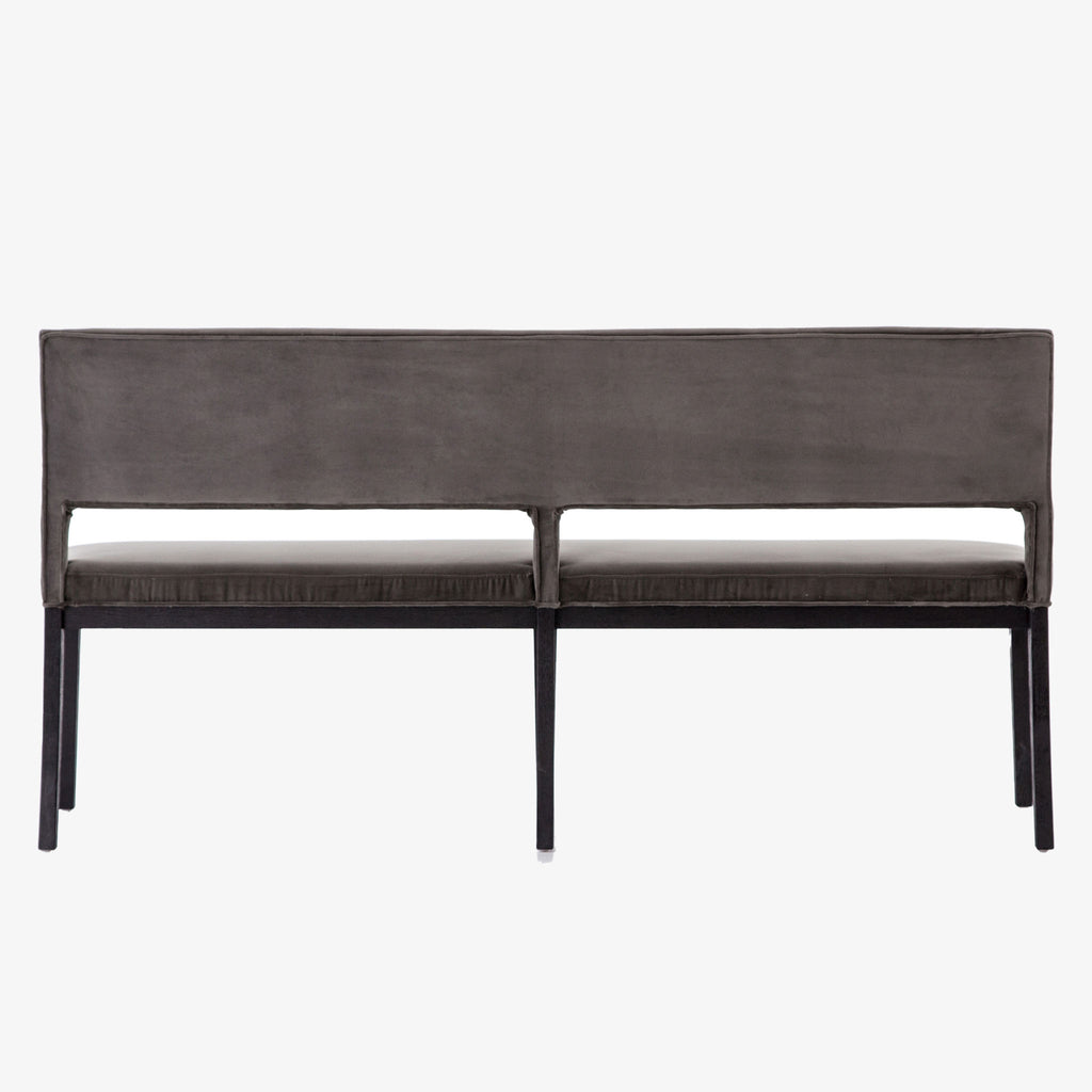 Back of Four hands furniture brand washed velvet dining bench with grey fabric seat and dark wood legs on a white background