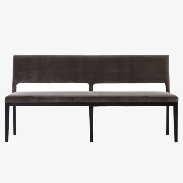 Four hands furniture brand washed velvet dining bench with grey fabric seat and dark wood legs on a white background
