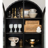 Cane and rattan boxes in a black cabinet with decorative items