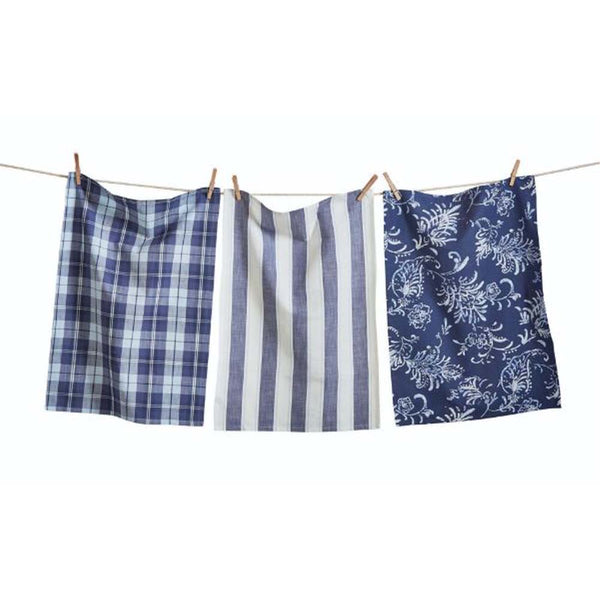 Set of three Blue Kitchen Towels in check and stripe and botanical print on a clothes line in front of a white background