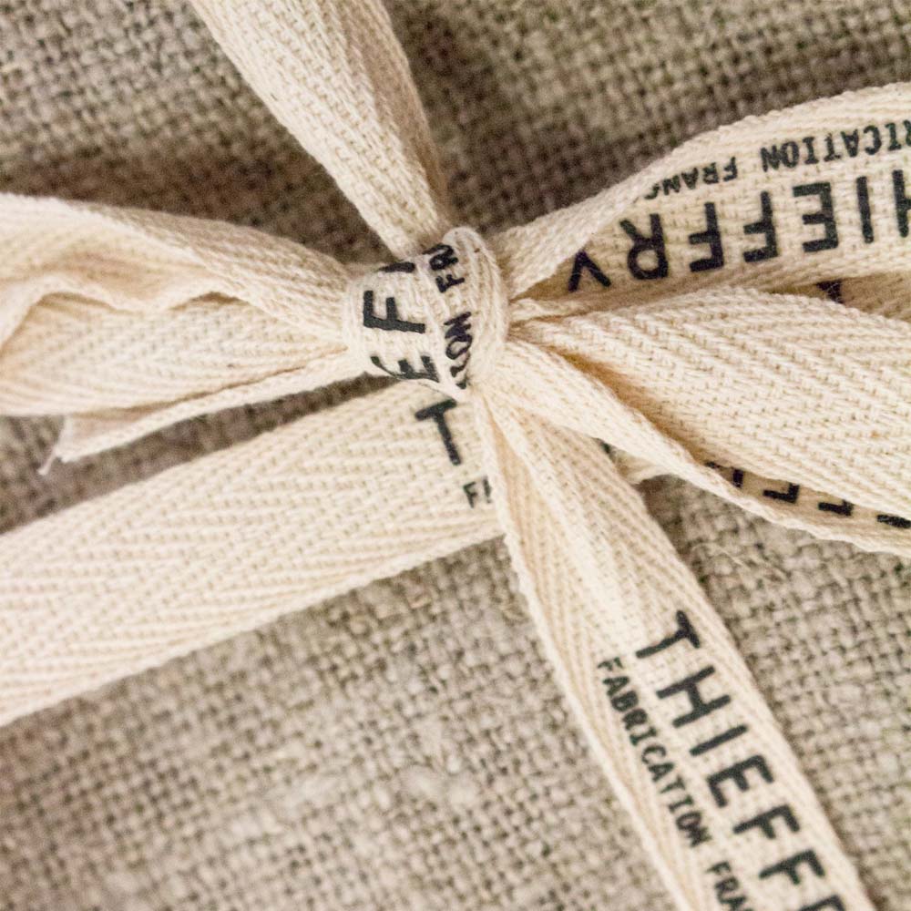 Close up of Set of two natural colored Belgian linen Thieffry tea towels tied with a bow 