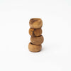 Set of four olive wood napkin rings stacked on a white background