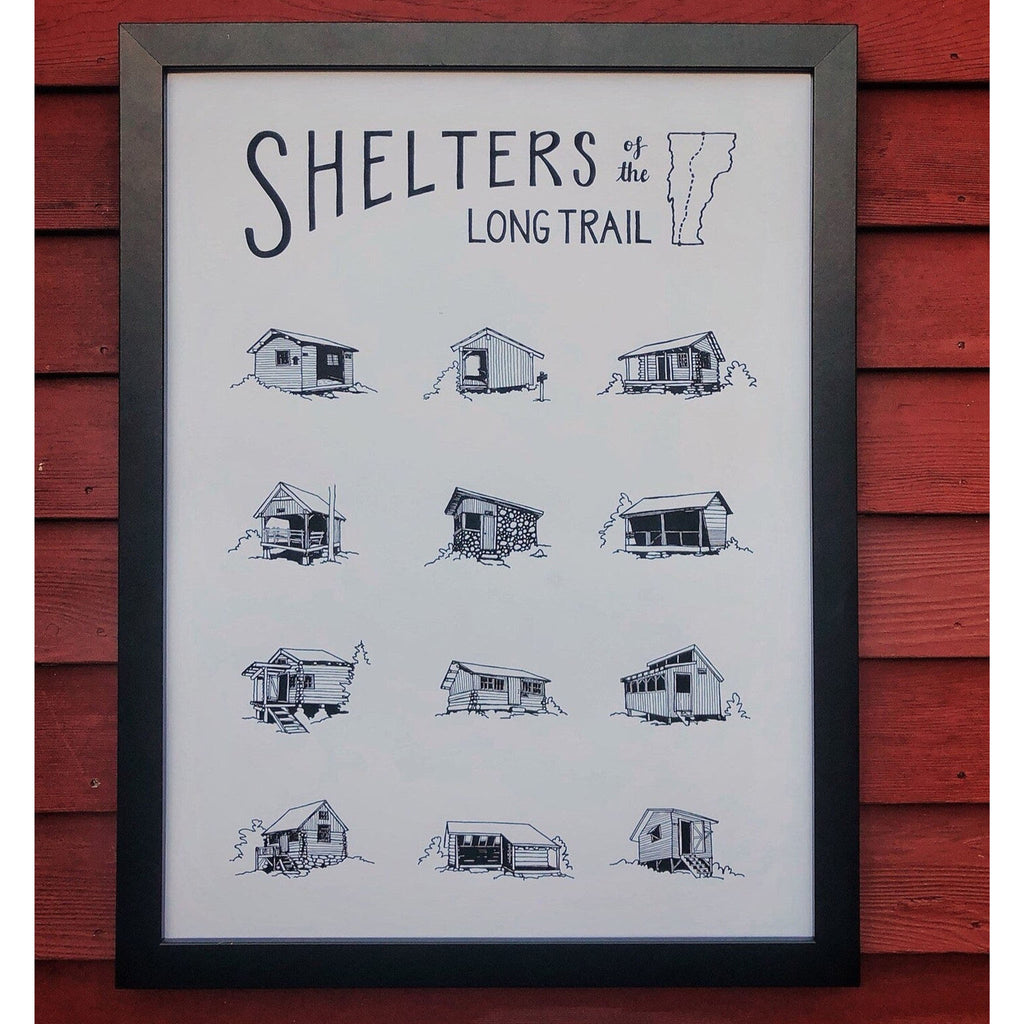 Framed poster of vermont long trail shelters hanging in front of wood