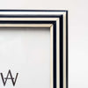 Close up of blue and white stripe picture frame on a white background