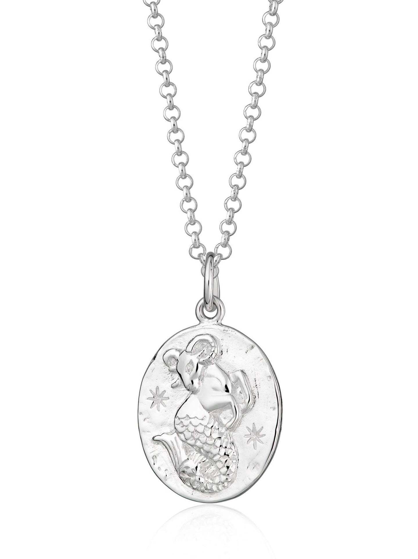 Scream Pretty brand silver Capricorn zodiac star sign necklaces on a white background