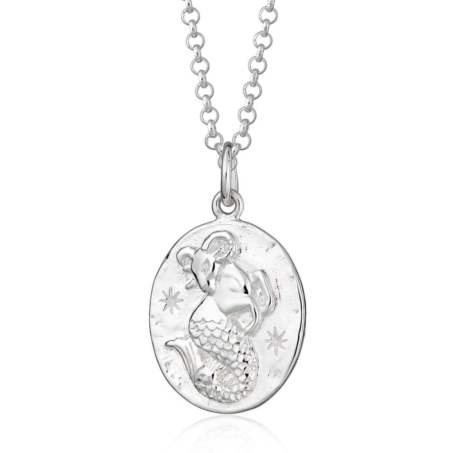 Scream Pretty brand silver Capricorn zodiac star sign necklaces on a white background
