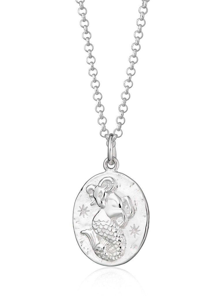 Scream Pretty brand silver Capricorn zodiac star sign necklaces on a white background