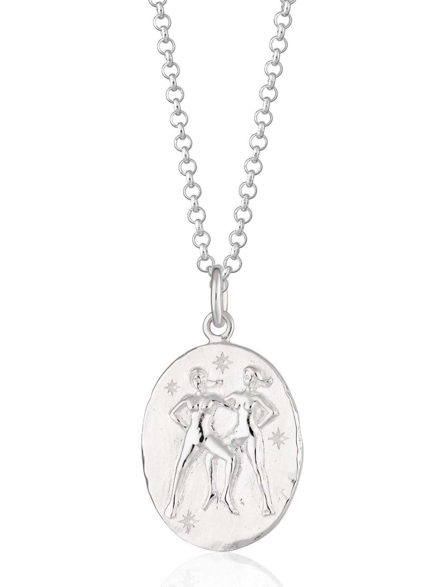 Scream Pretty brand silver Gemini zodiac star sign necklaces on a white background