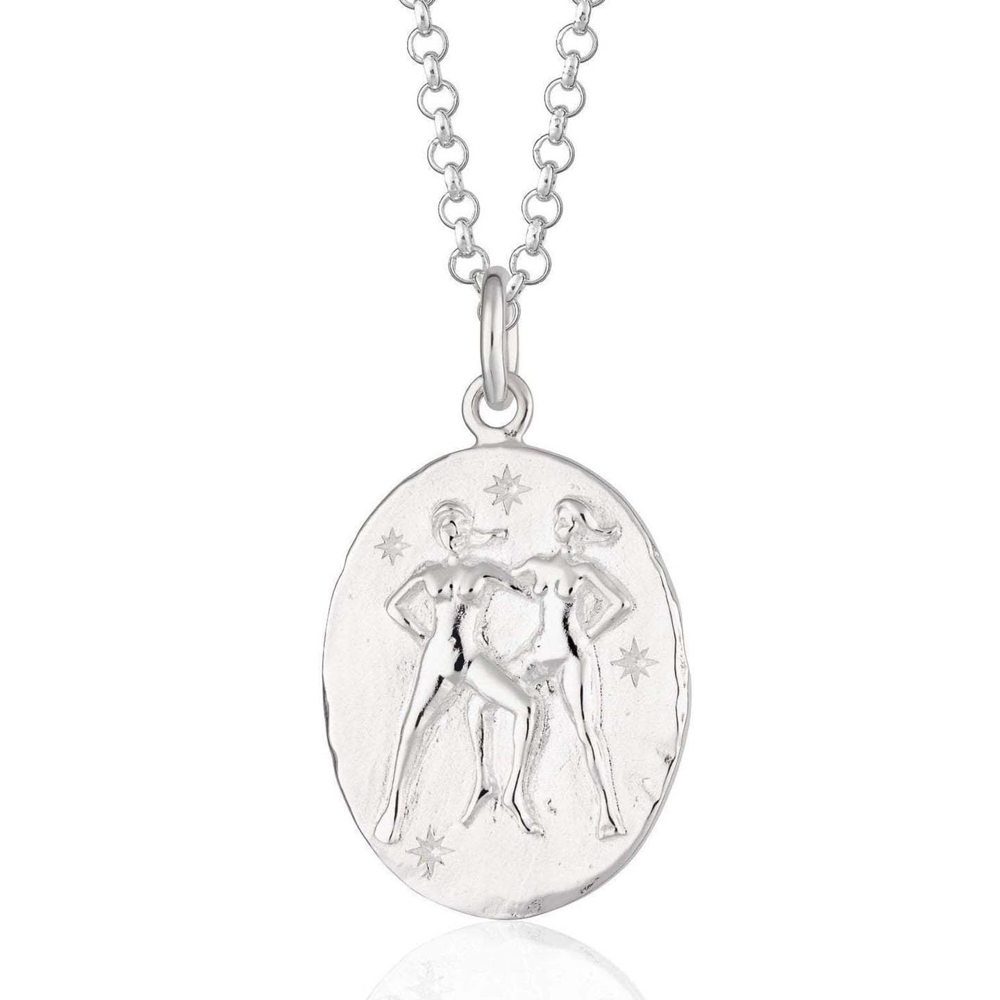 Scream Pretty brand silver Gemini zodiac star sign necklaces on a white background