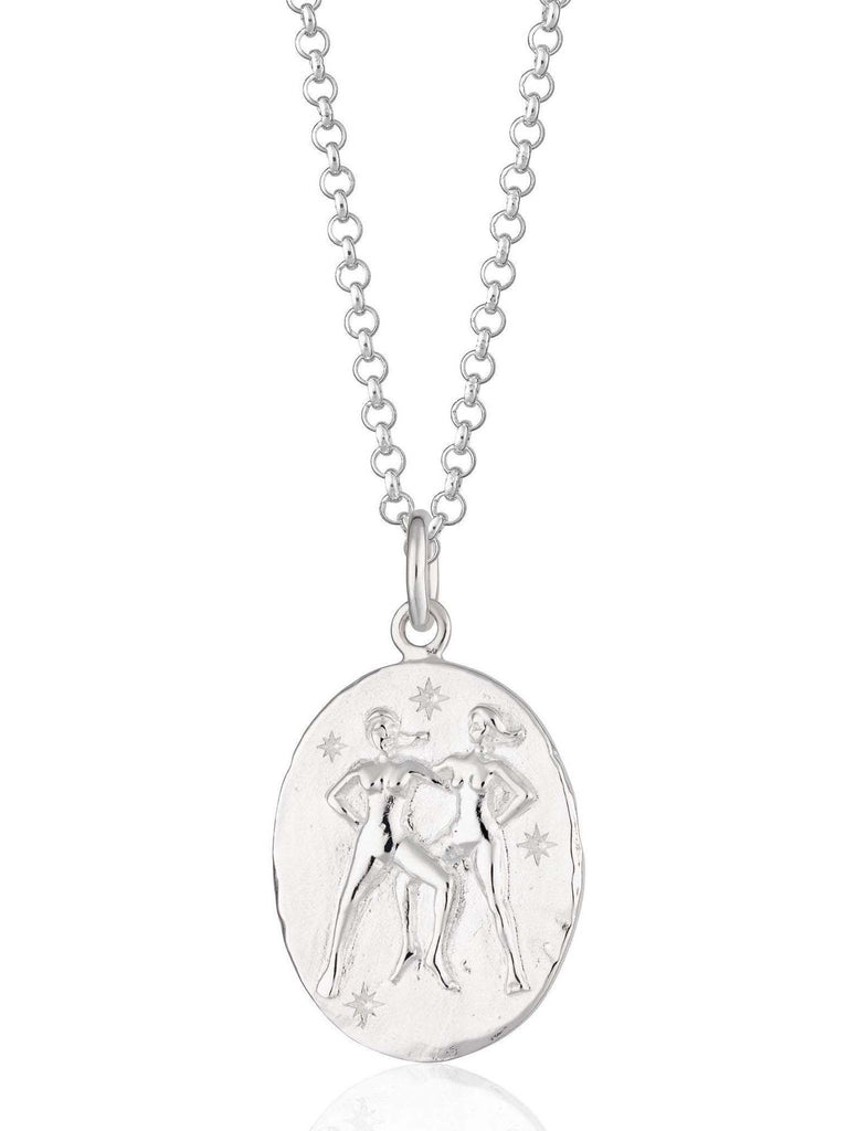 Scream Pretty brand silver Gemini zodiac star sign necklaces on a white background