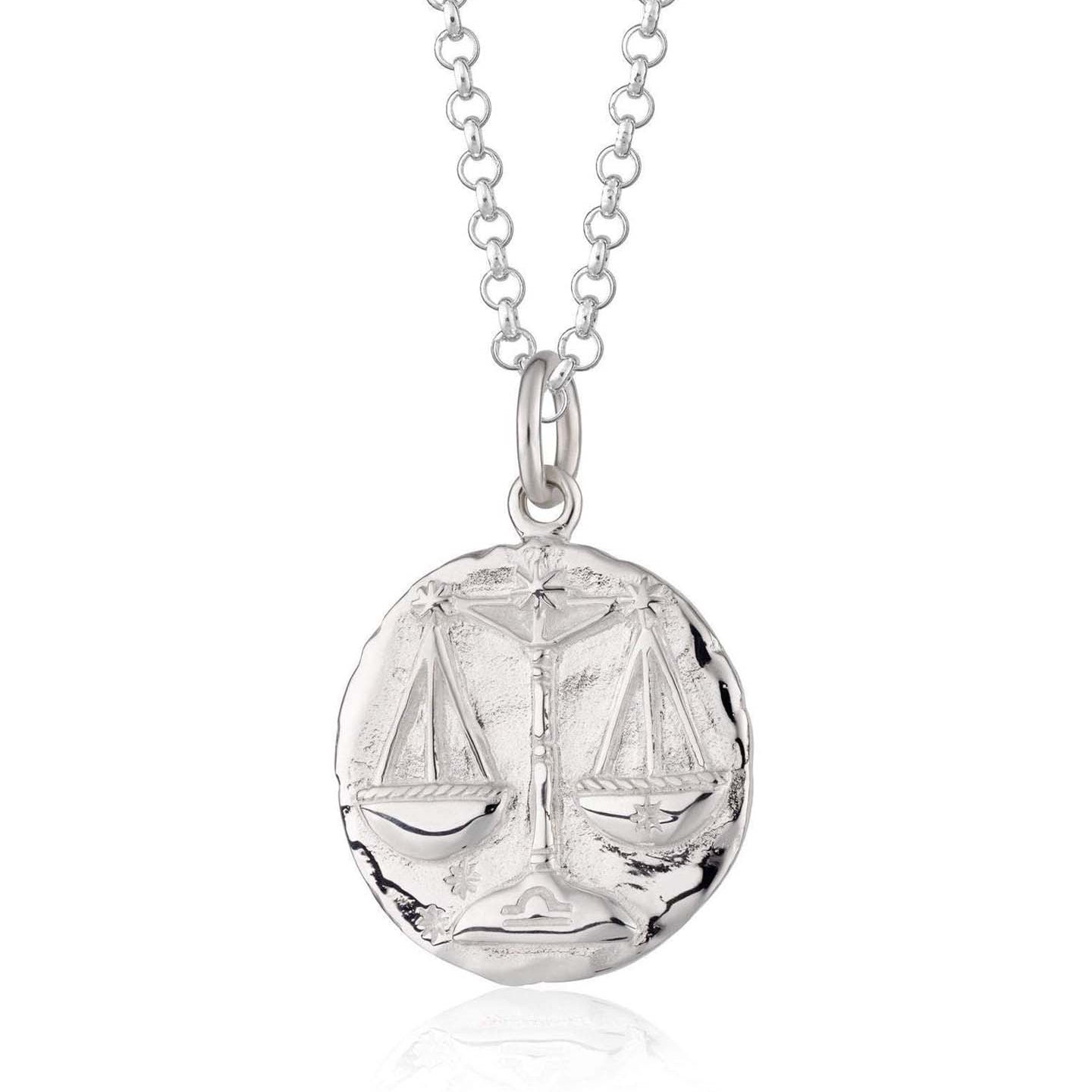 Scream Pretty brand silver Libra zodiac star sign necklaces on a white background