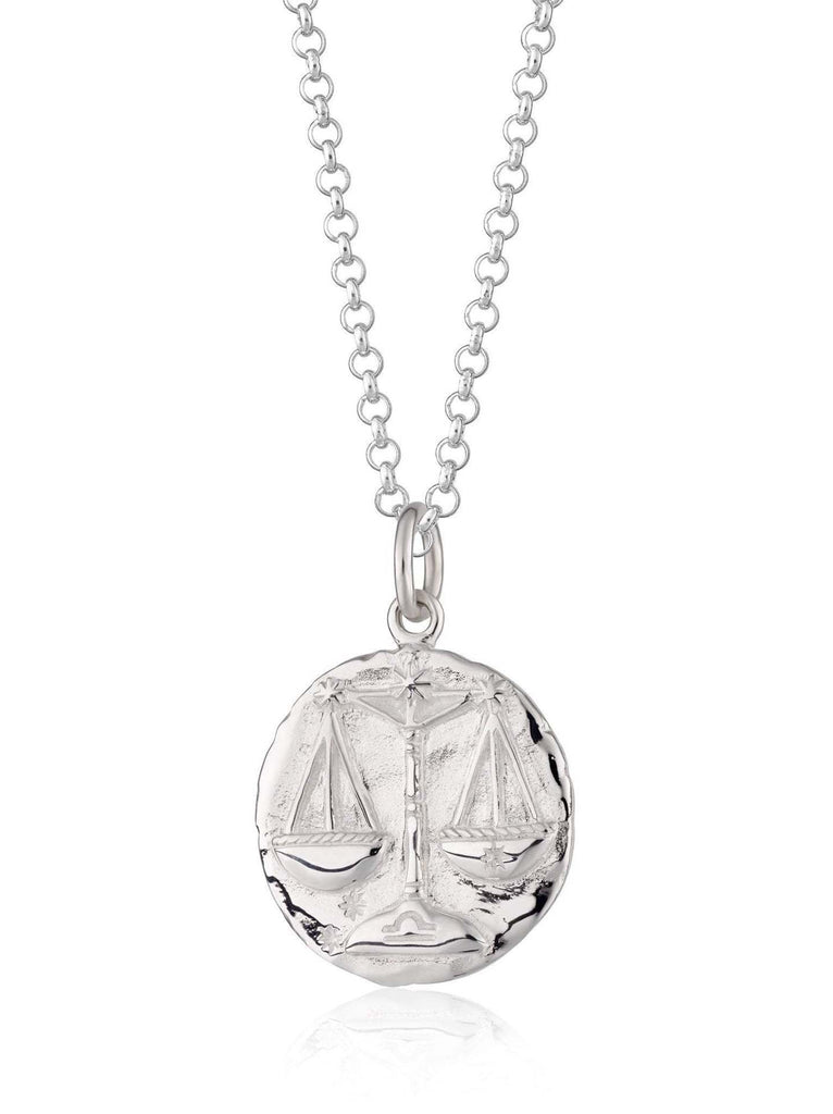 Scream Pretty brand silver Libra zodiac star sign necklaces on a white background