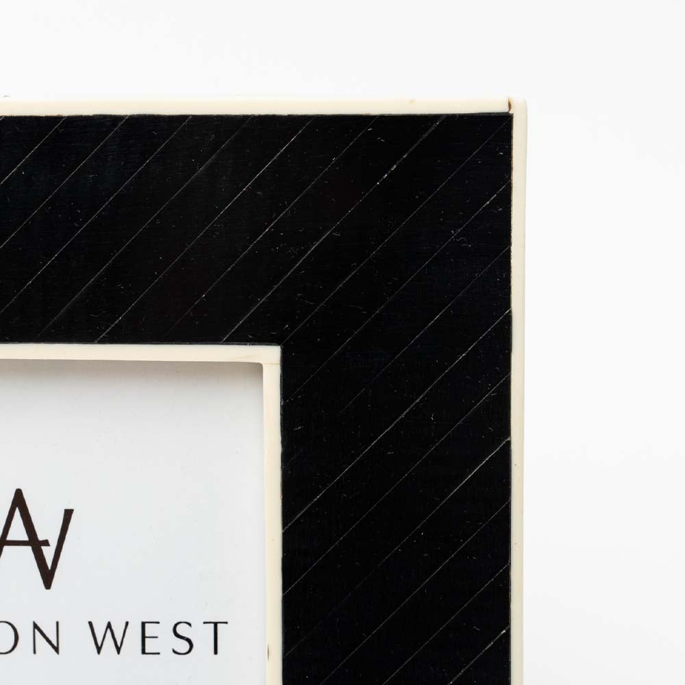 Close up of Black square photo frame for 4"x4" photo on a white background  