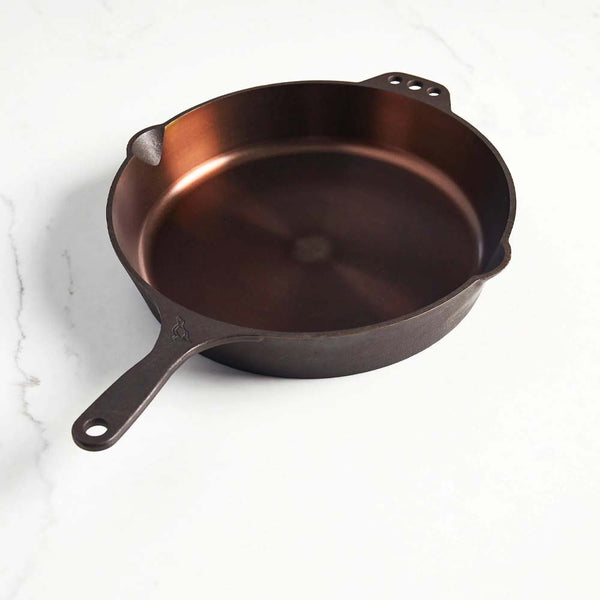 Smithey cast iron 12 inch skillet on a white background