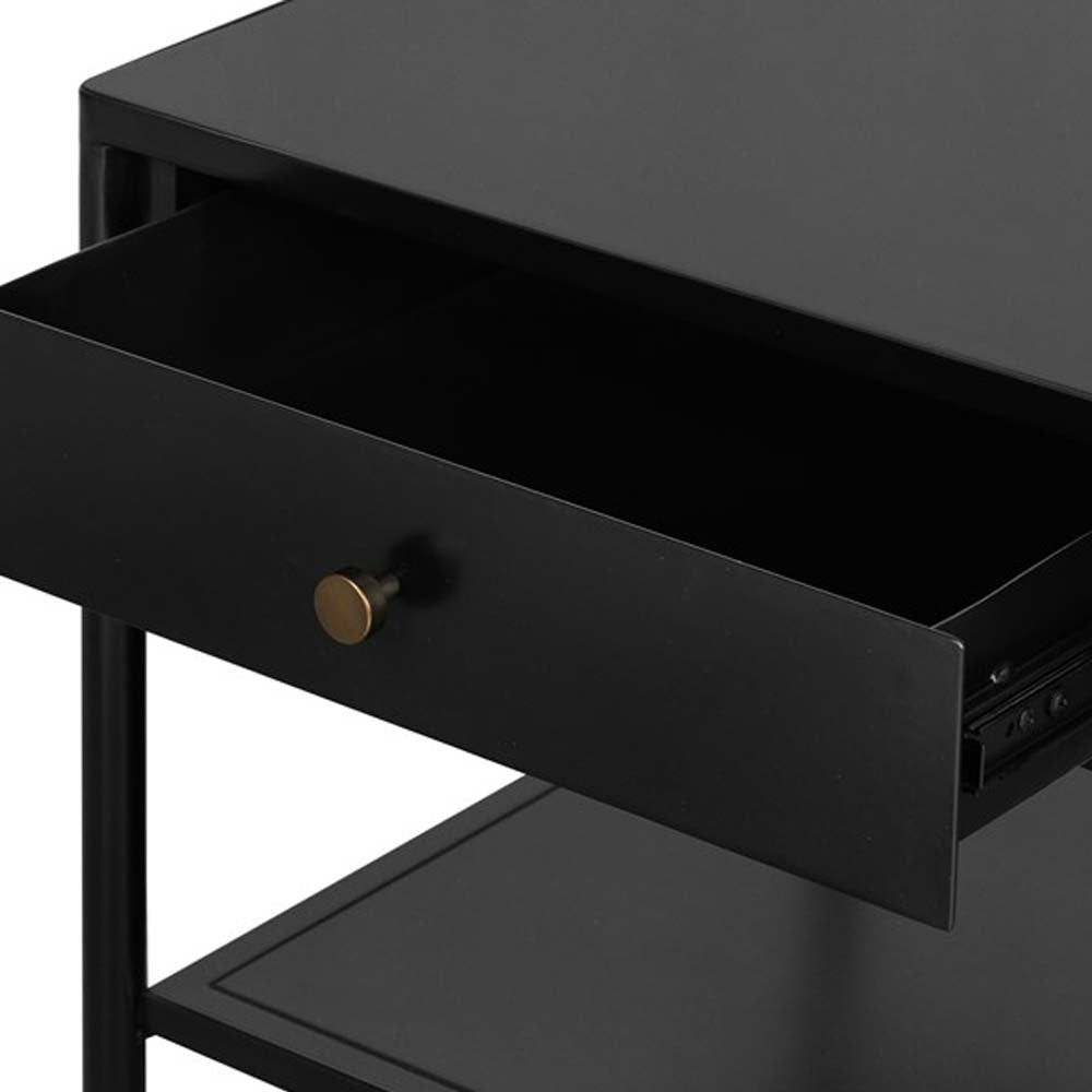 Close up of black single drawer 'Soto' end table by four hands furniture on a white background