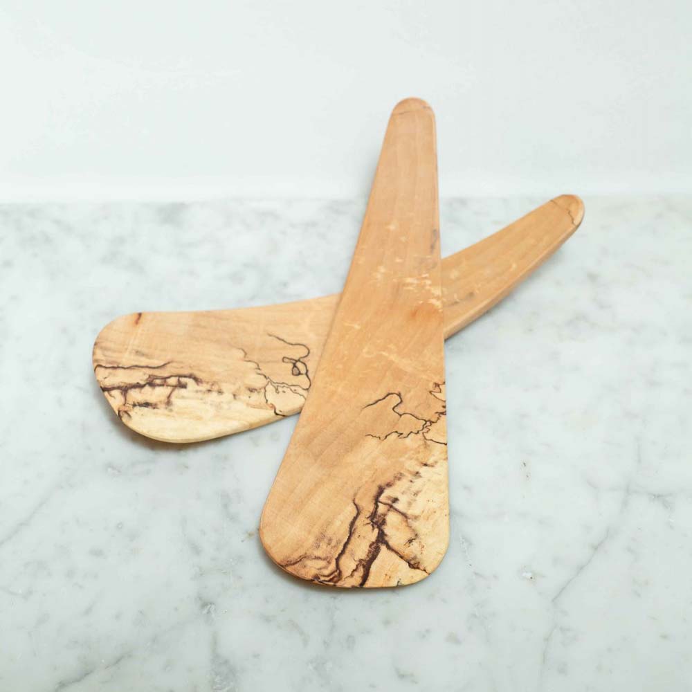 Spalted maple salad tossers on a marble counter 