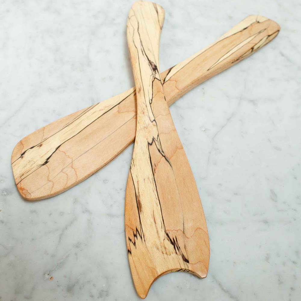 Spalted maple salad tossers on a marble counter 