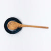 Indigo handmade in Vermont spoon rest with olive wood spoon on a white background