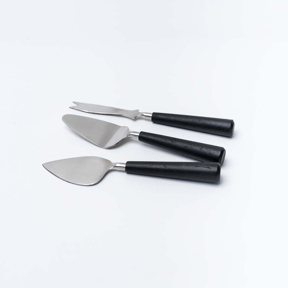 Stainless steel cheese knife set with black wood handles on a white background