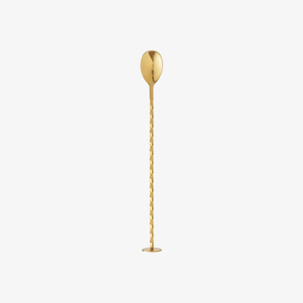 Brass cocktail spoon with base for standing on a white background