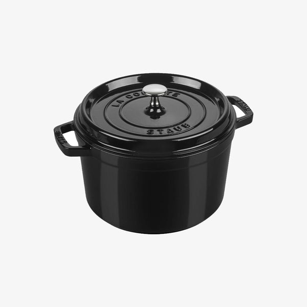 Staub black five quart cast iron pot in black on a white background