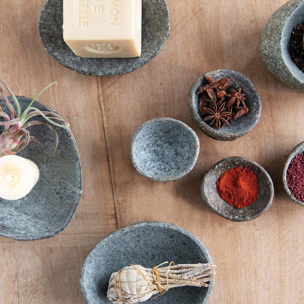 Natural stone dishes on a counter with spices