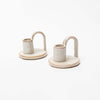 Ivory glazed Stoneware Candle Holder with finger loop on a white background