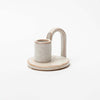 Ivory glazed Stoneware Candle Holder with finger loop on a white background