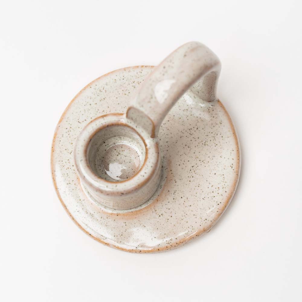 Ivory glazed Stoneware Candle Holder with finger loop on a white background