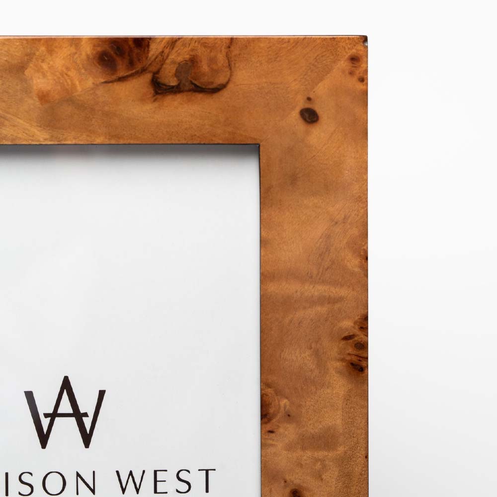 Close up of two's company brand burl wood picture frame on a white background