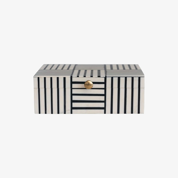 Black and white block stripe box with gold knob on lid on a white background