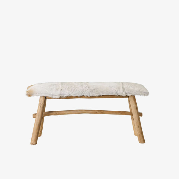 wood and goatskin bench on a white background