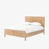 Natural wood and cane 'Sydney' bed by Four hands furniture on a white background