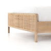 Natural wood and cane 'Sydney' bed by Four hands furniture on a white background