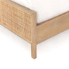 Close up of Natural wood and cane 'Sydney' bed by Four hands furniture on a white background