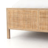 Close up of Natural wood and cane 'Sydney' bed by Four hands furniture on a white background