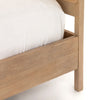 Natural wood and cane 'Sydney' bed by Four hands furniture on a white background