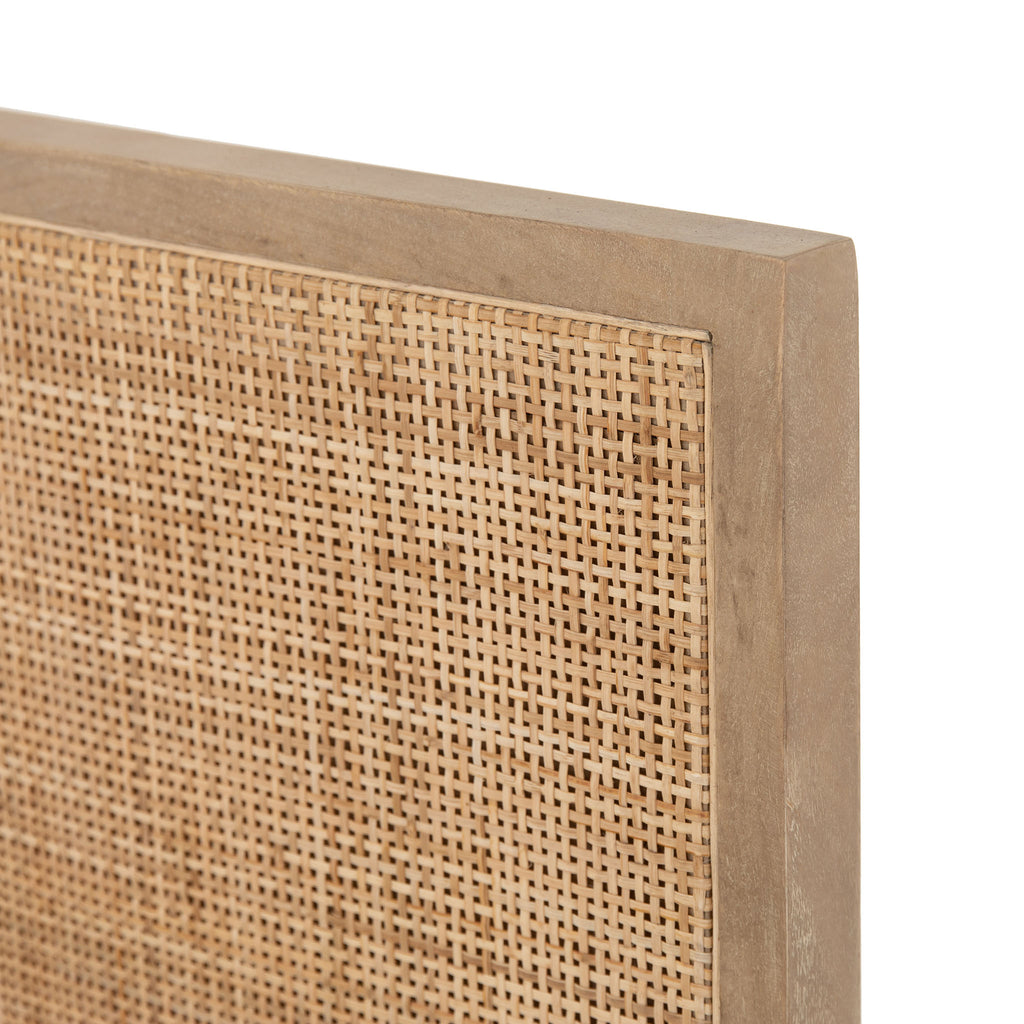 Close up of Natural wood and cane 'Sydney' bed by Four hands furniture on a white background