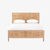 Natural wood and cane 'Sydney' bed by Four hands furniture on a white background