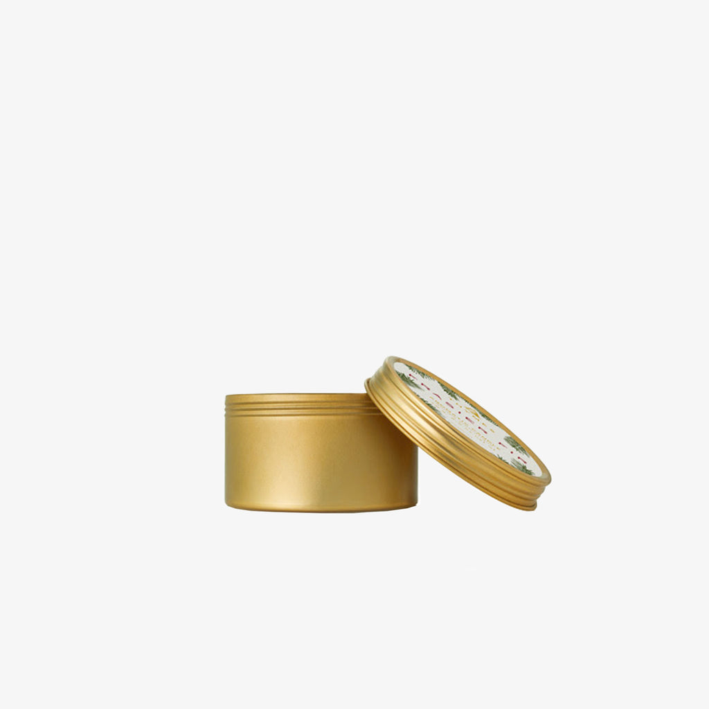 Thymes fraiser fir candle in gold travel tin on a white background