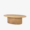 Light wood oval coffee table with reeded wood base on a white background