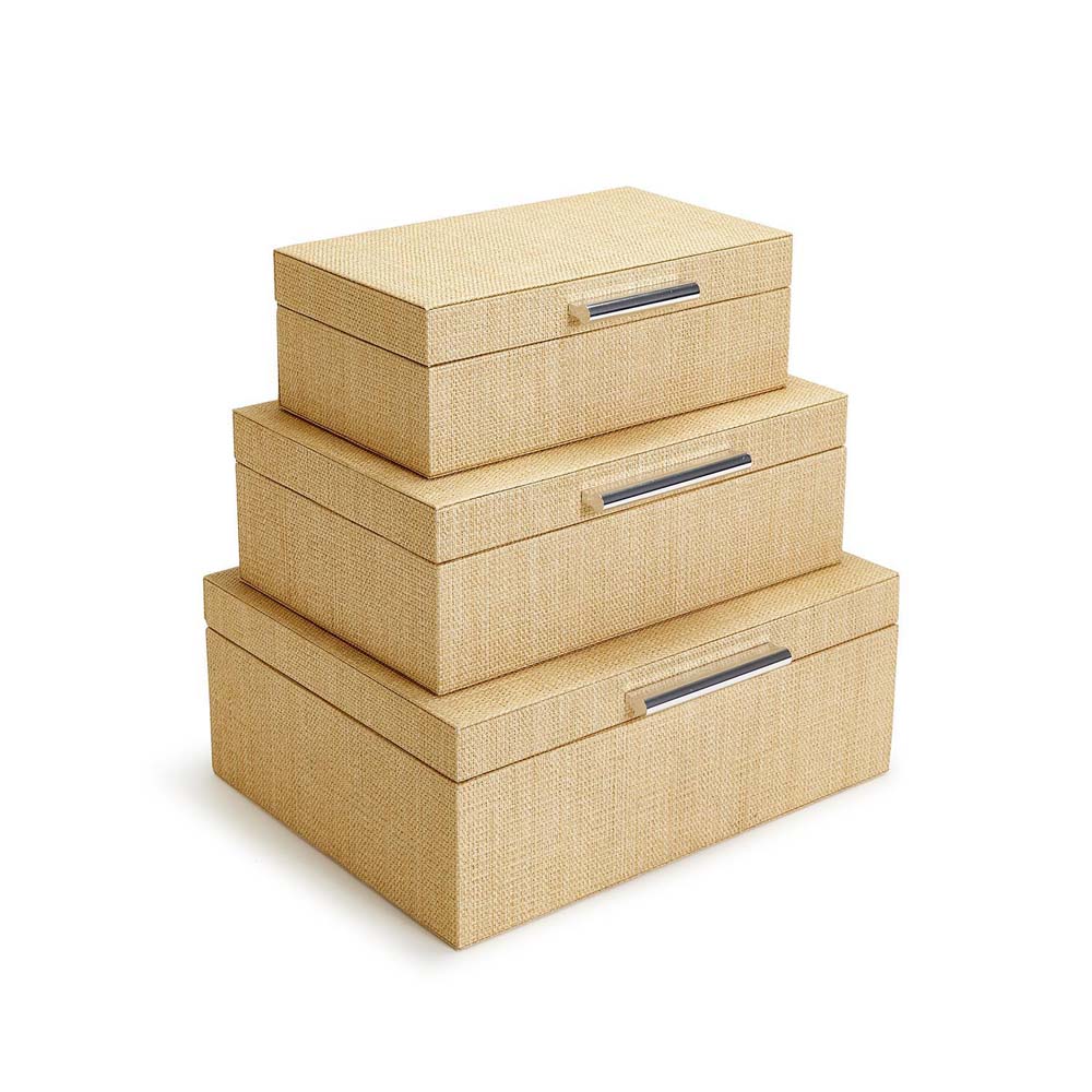Three cane wrapped nesting boxes with silver handles and hinge lids on a white background