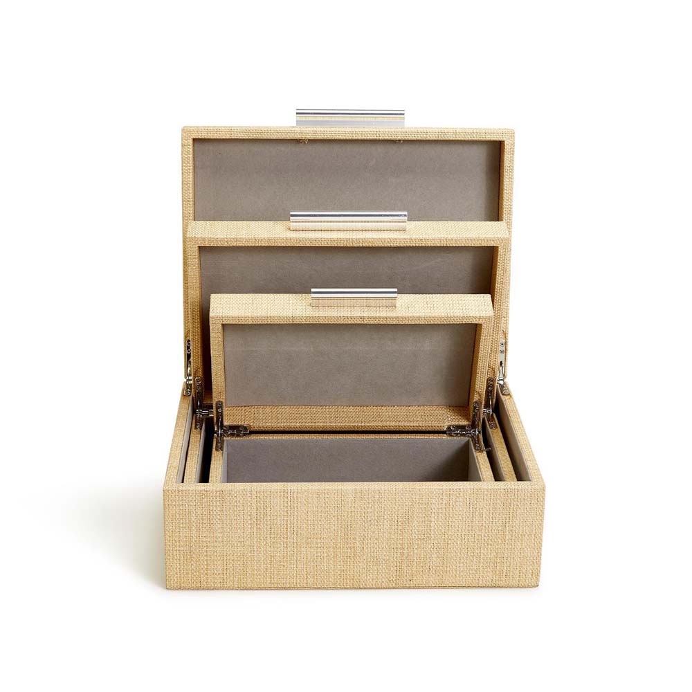 Three cane wrapped nesting boxes with silver handles and hinge lids on a white background