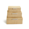 Three cane wrapped nesting boxes with silver handles stacked on a white background