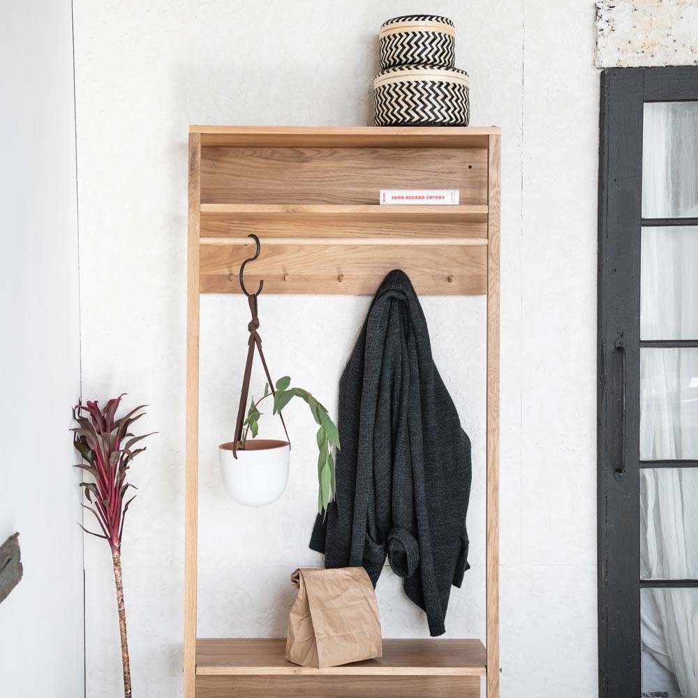 White hanging planter on hook in mudroom space