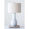 Tall white terracotta lamp with linen shade  on a wood riser