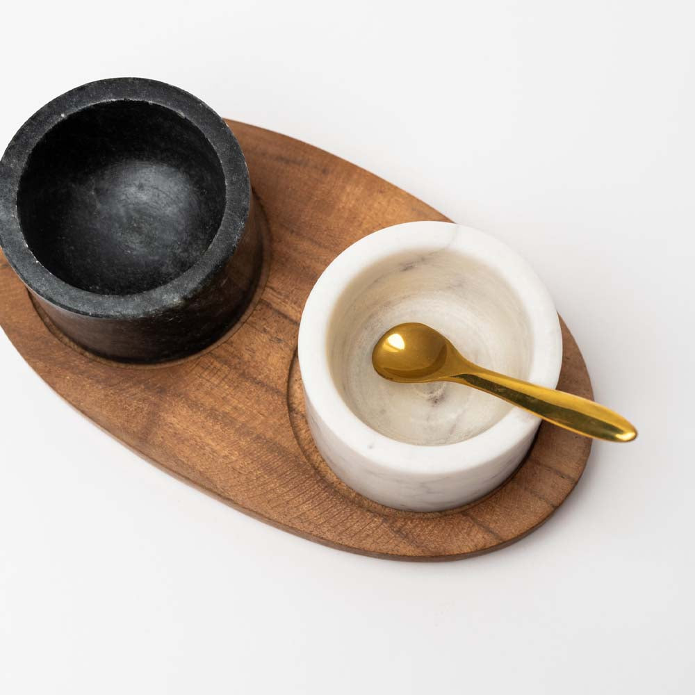 Closeup Marble Bowls on Mango Wood Tray with Brass Salt Spoon on a white background