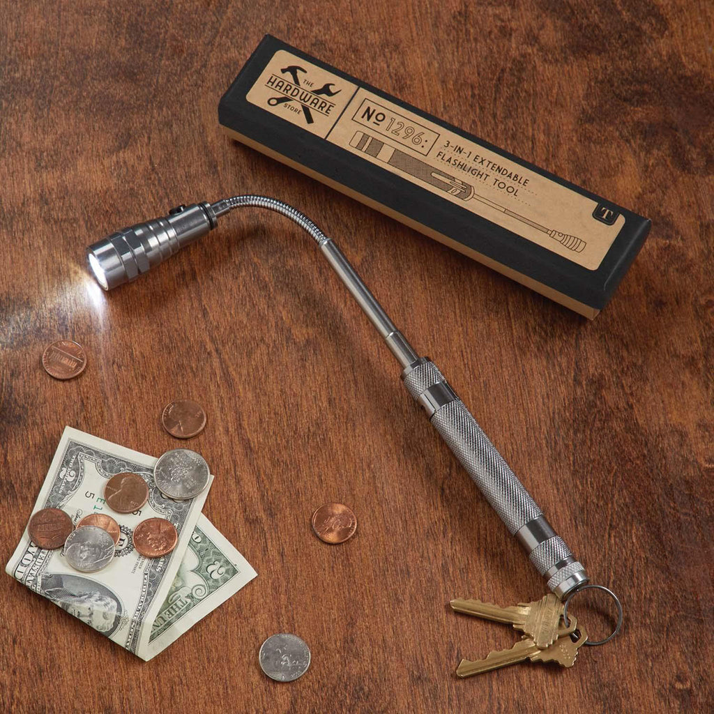 Three in one extendable flashlight and box on a wood table with money